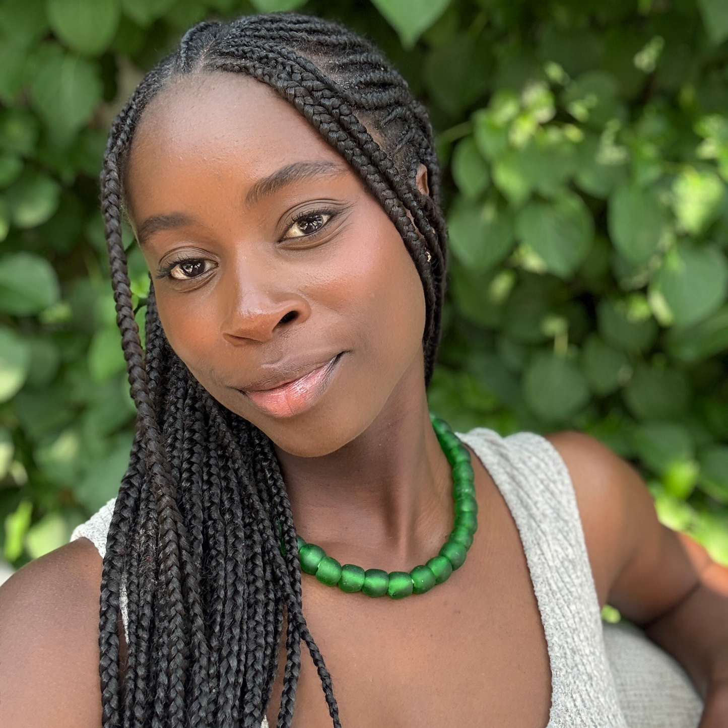 Asase bold necklace in green from Tòma Lina, shown how to wear around the neck