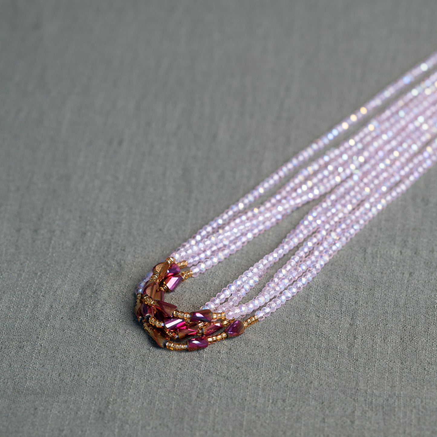 Luxury waist beads in blush pink and gold – handmade African body jewelry symbolizing self-love and feminine energy.