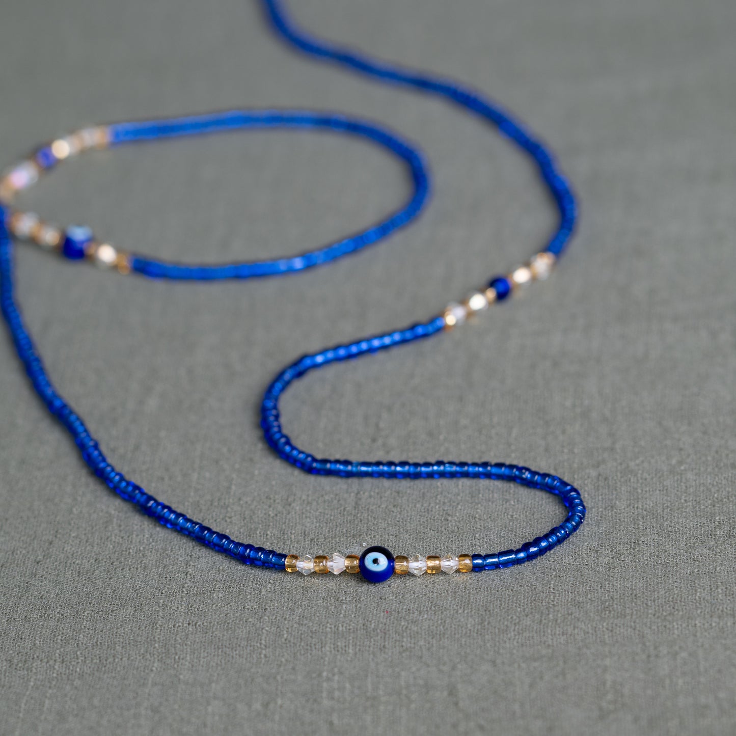 blue evil eye waist beads – handmade Ghanaian body jewelry by Tòma Lina