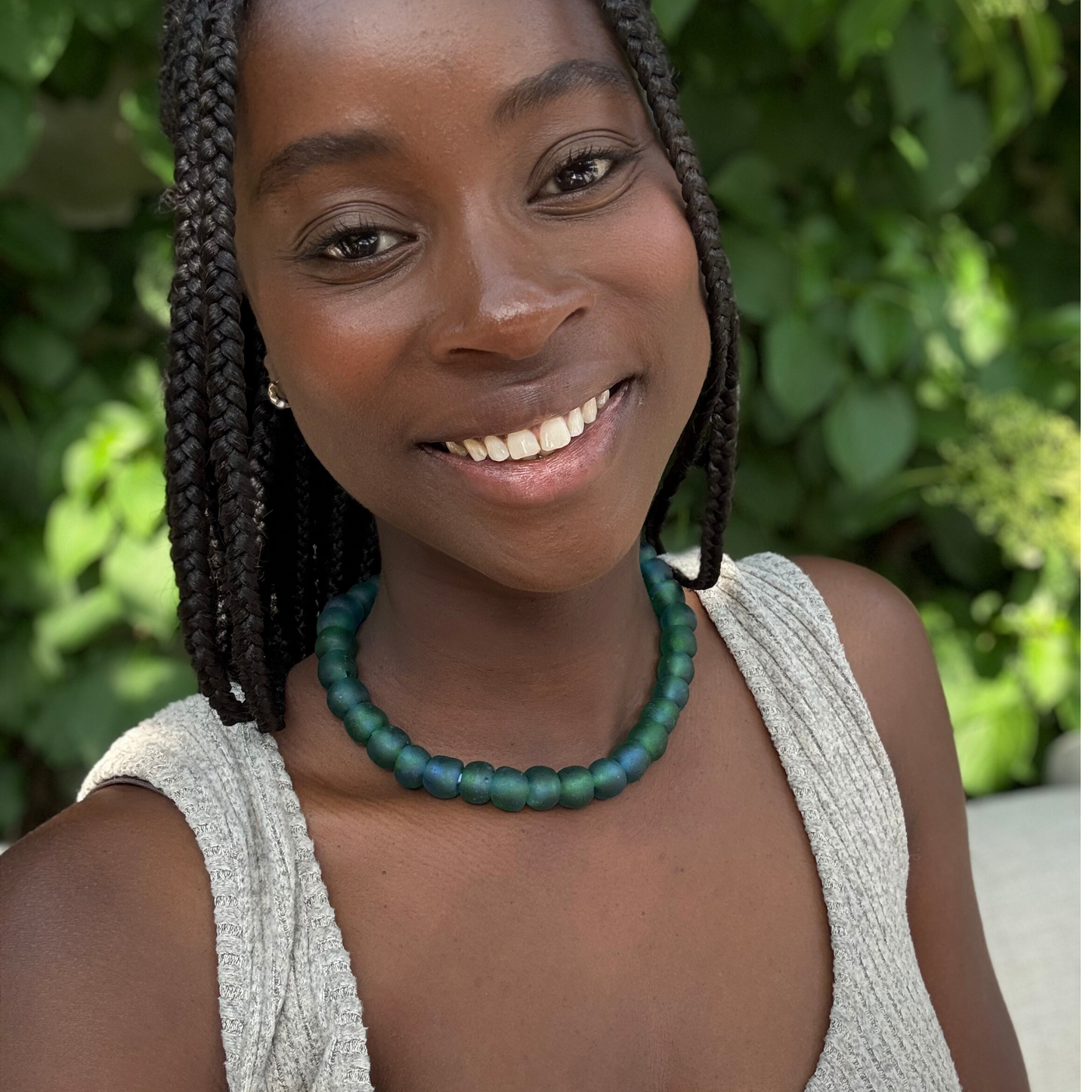 Deep waters bold necklace in blue/green from Tòma Lina, shown how to wear around the neck
