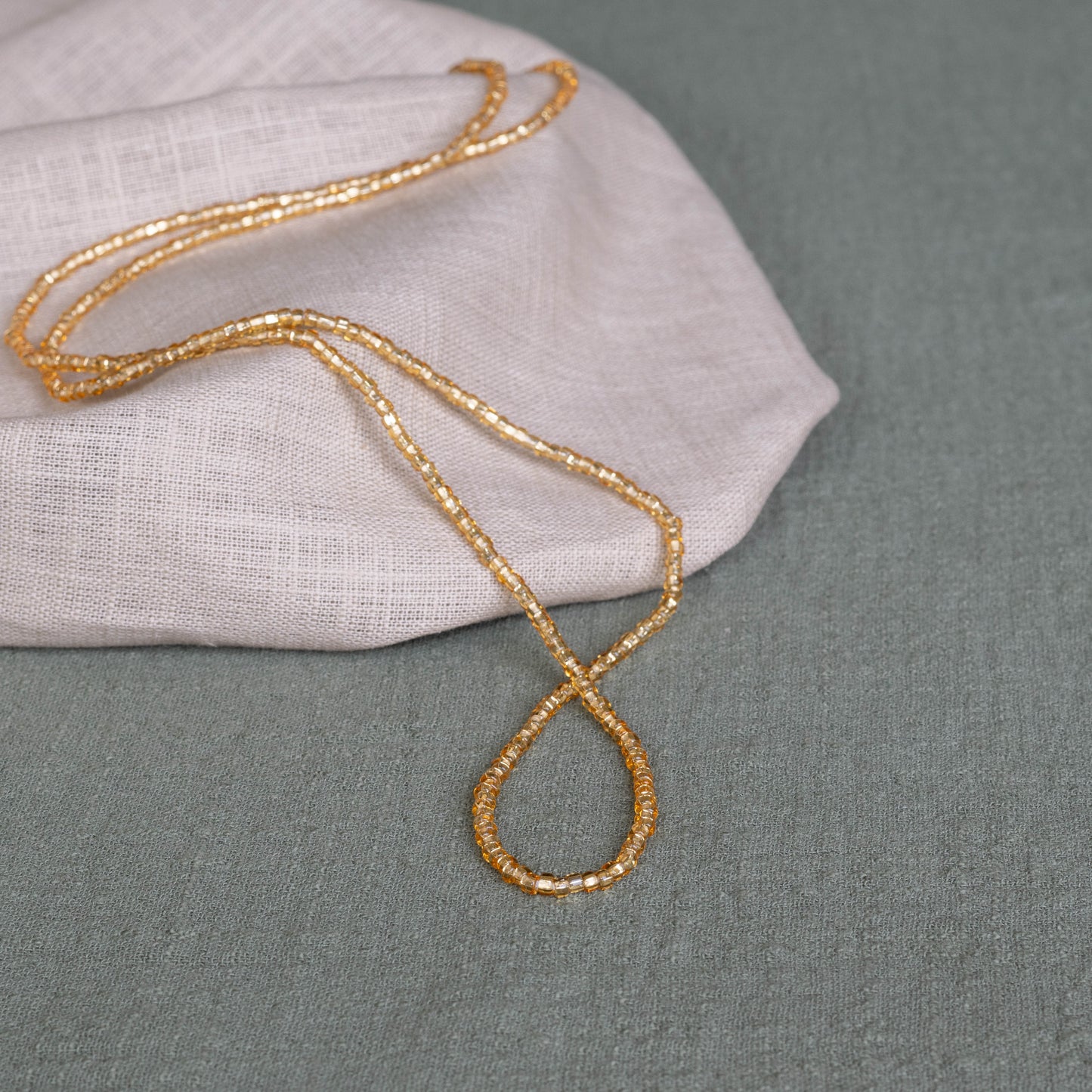 Goldie waist beads in gold – handmade Ghanaian body jewelry by Tòma Lina