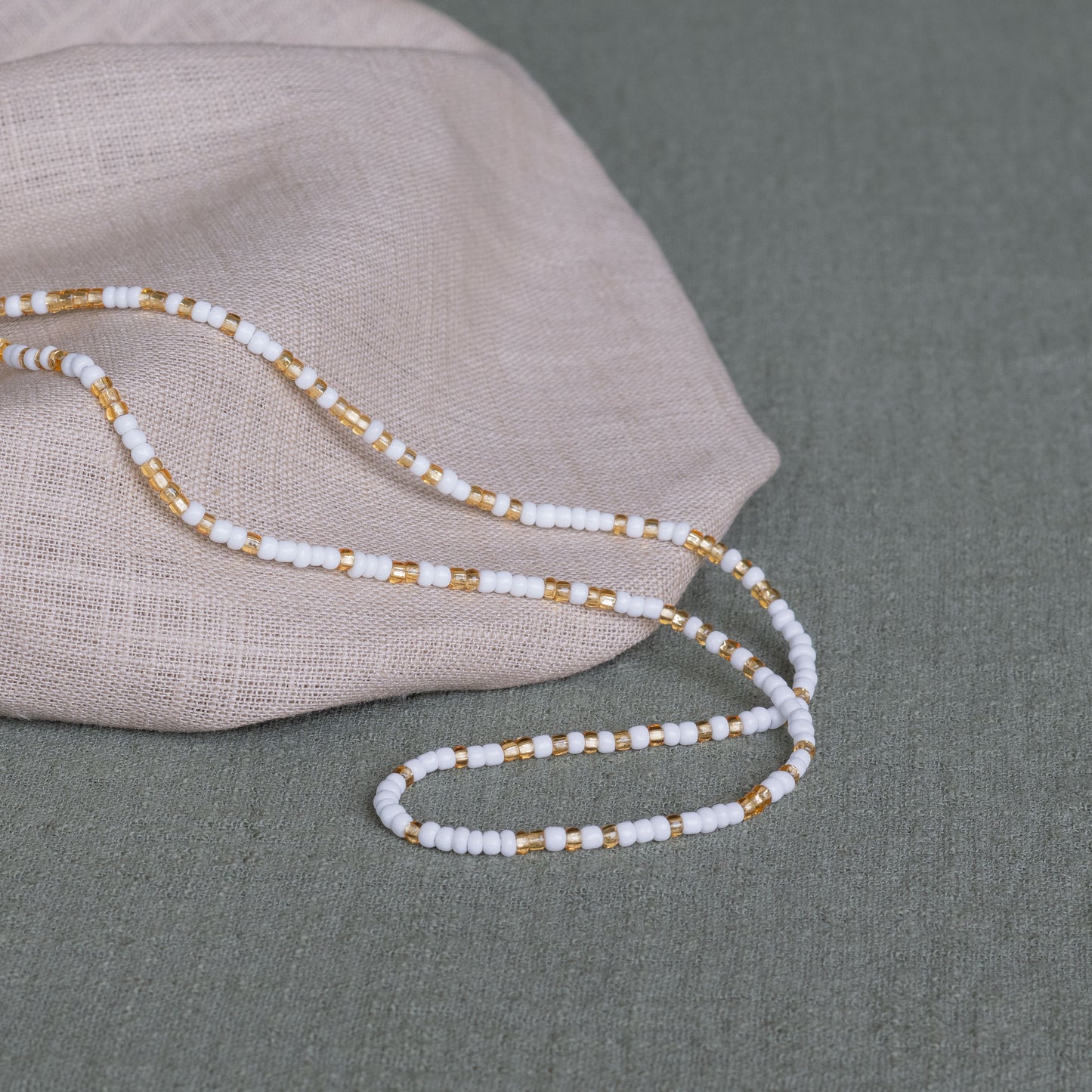 Ivory waist beads in white – handmade Ghanaian body jewelry by Tòma Lina