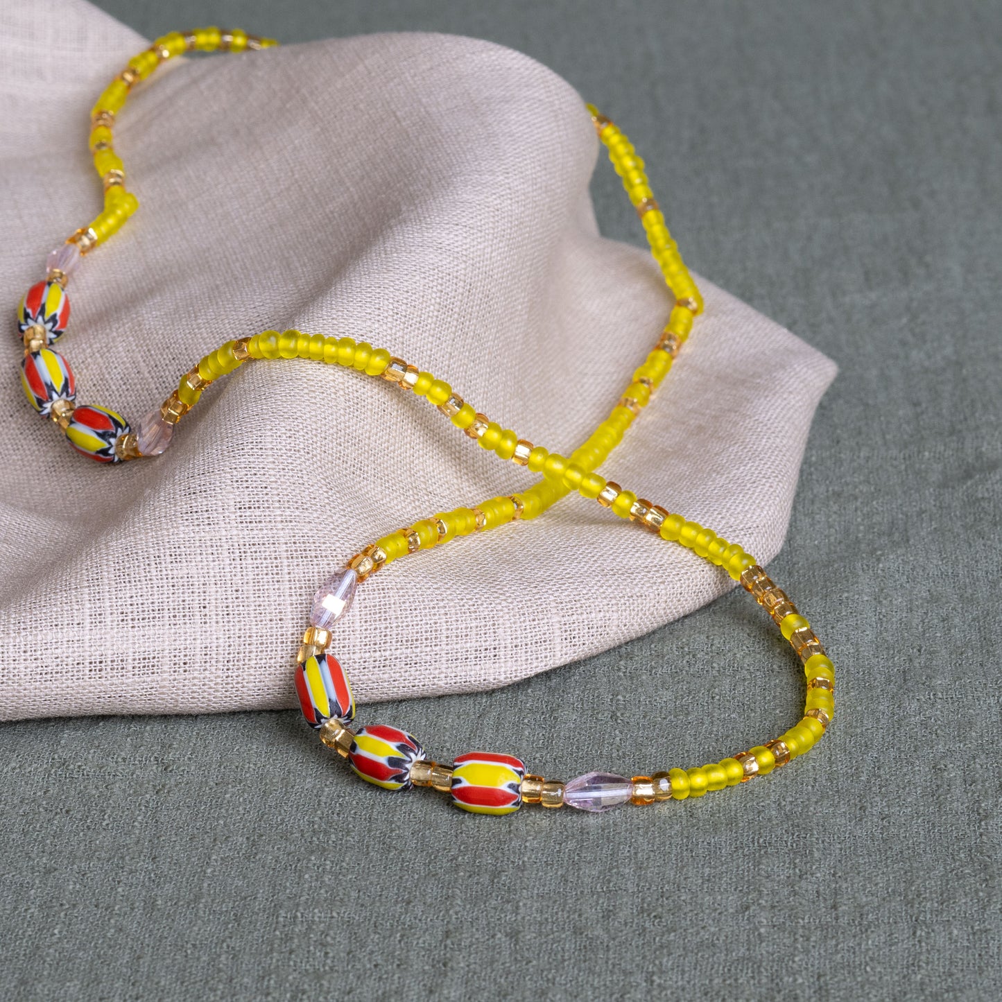 Yellow Krobo waist beads in yellow – handmade Ghanaian body jewelry by Tòma Lina
