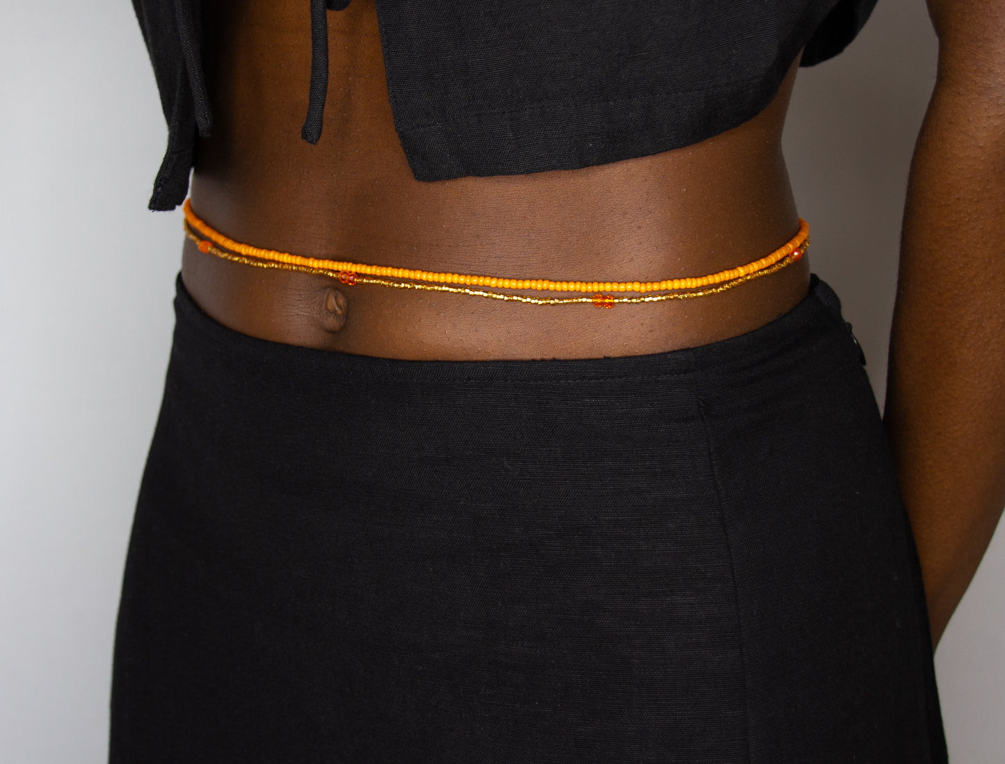 How to wear pumpkin spice waist beads in orange from Tòma Lina – handmade body jewelry
