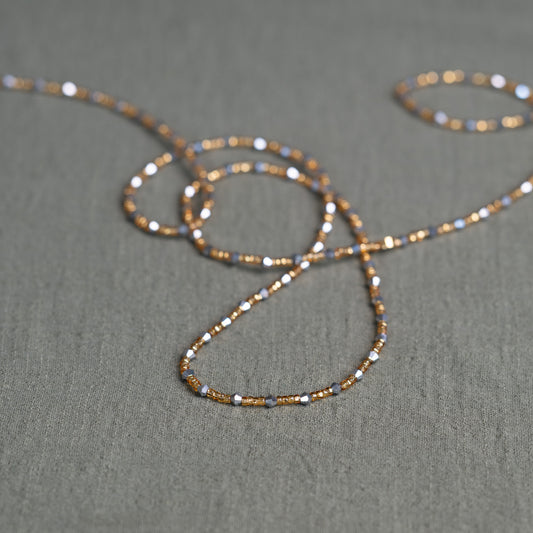 Handmade African waist beads in silver-grey and gold tones – tie-on body jewelry from Ghana for spiritual strength and balance.