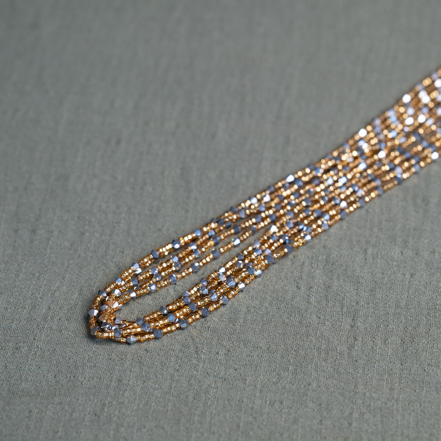 Handmade African waist beads in silver-grey and gold tones – tie-on body jewelry from Ghana for spiritual strength and balance.