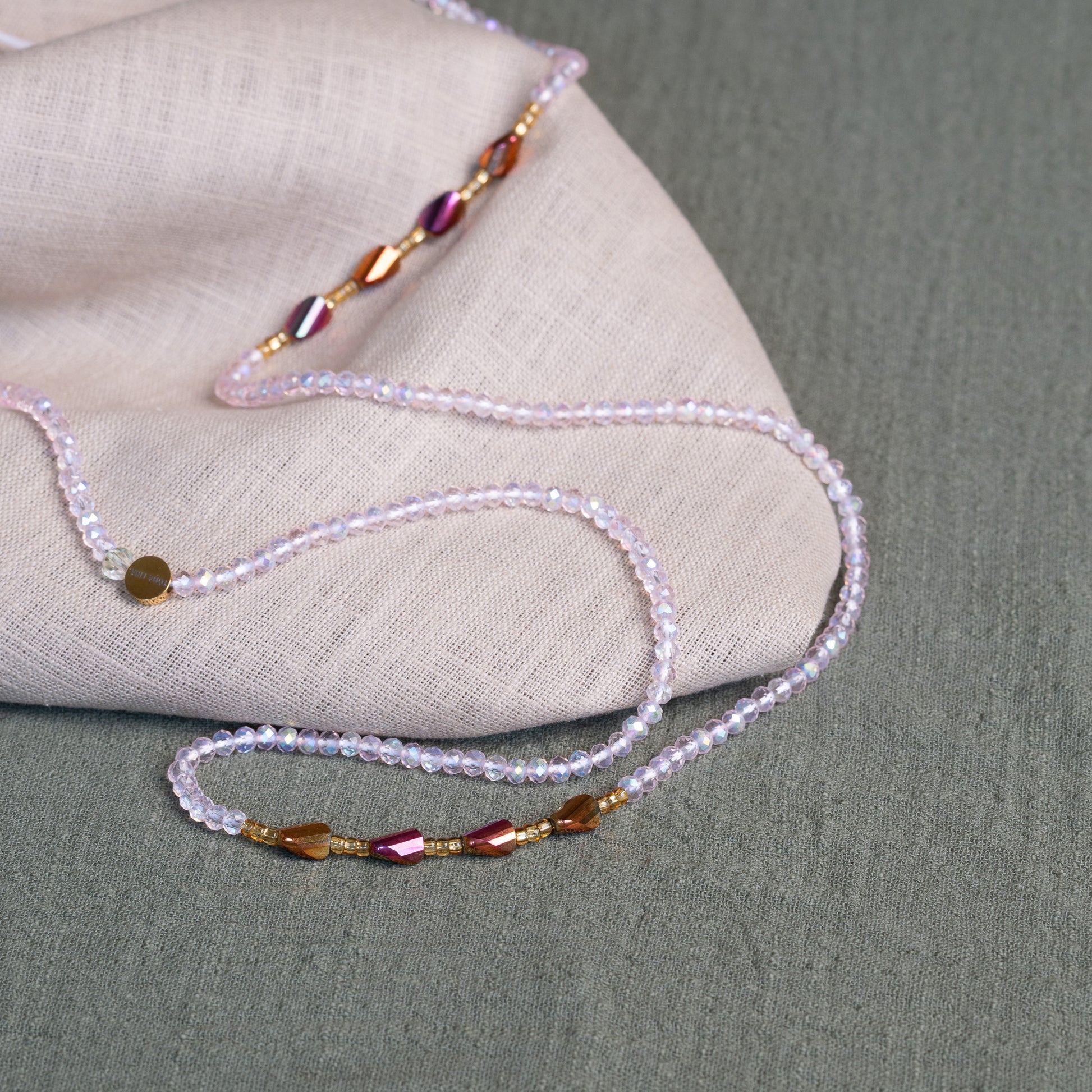 Luxury waist beads in blush pink and gold – handmade African body jewelry symbolizing self-love and feminine energy.