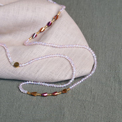 Luxury waist beads in blush pink and gold – handmade African body jewelry symbolizing self-love and feminine energy.