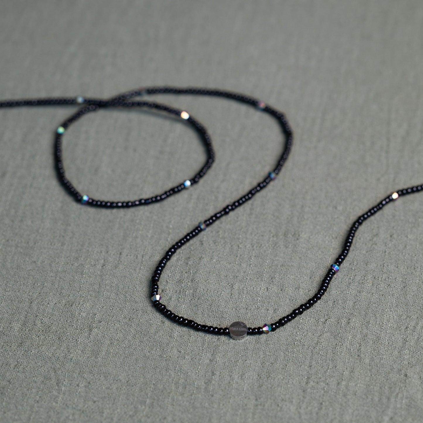 Tòma Lina Black Pearl waist bead, handmade with deep black Ghanaian beads symbolizing protection, grounding and feminine power.