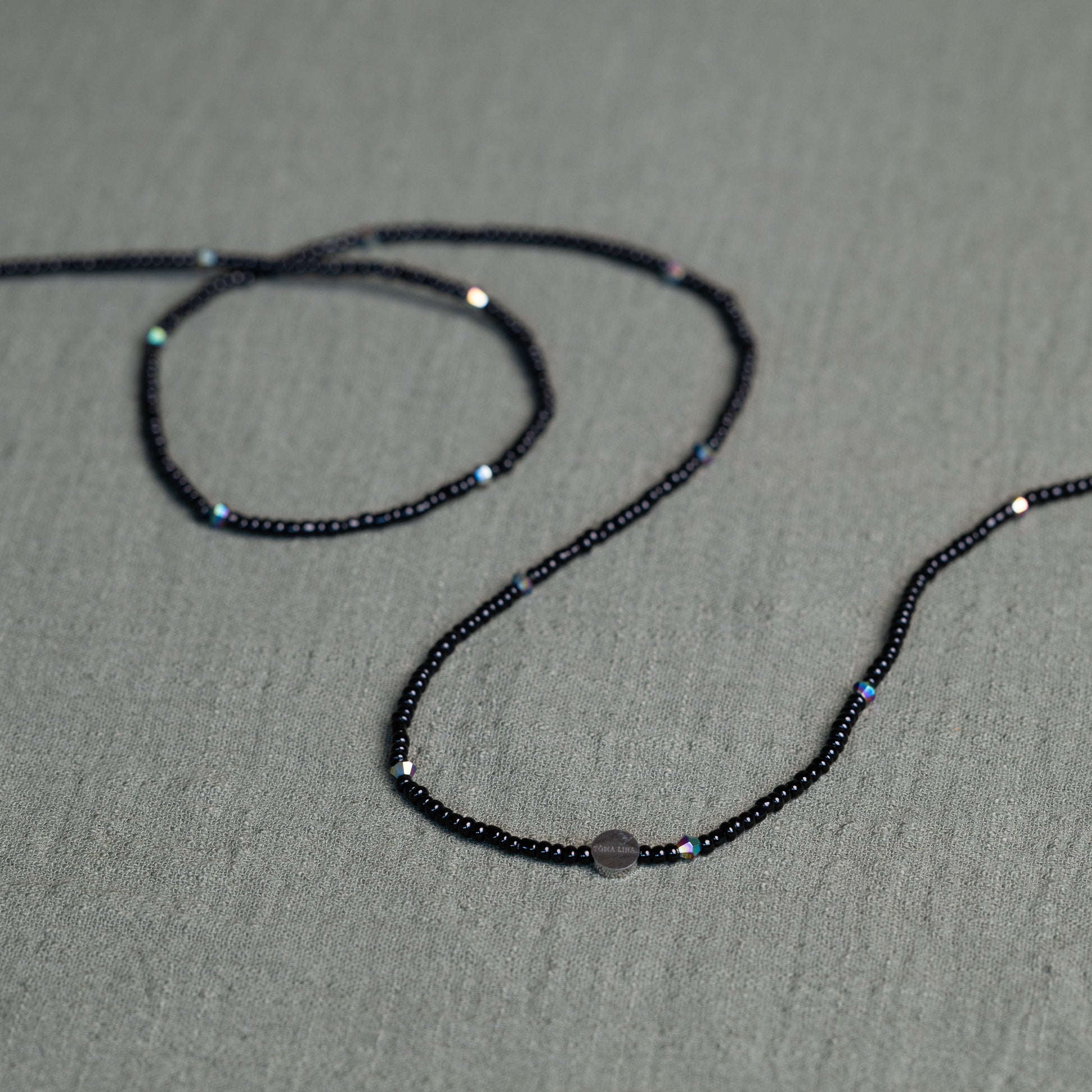 Tòma Lina Black Pearl waist bead, handmade with deep black Ghanaian beads symbolizing protection, grounding and feminine power.