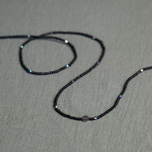 Tòma Lina Black Pearl waist bead, handmade with deep black Ghanaian beads symbolizing protection, grounding and feminine power.