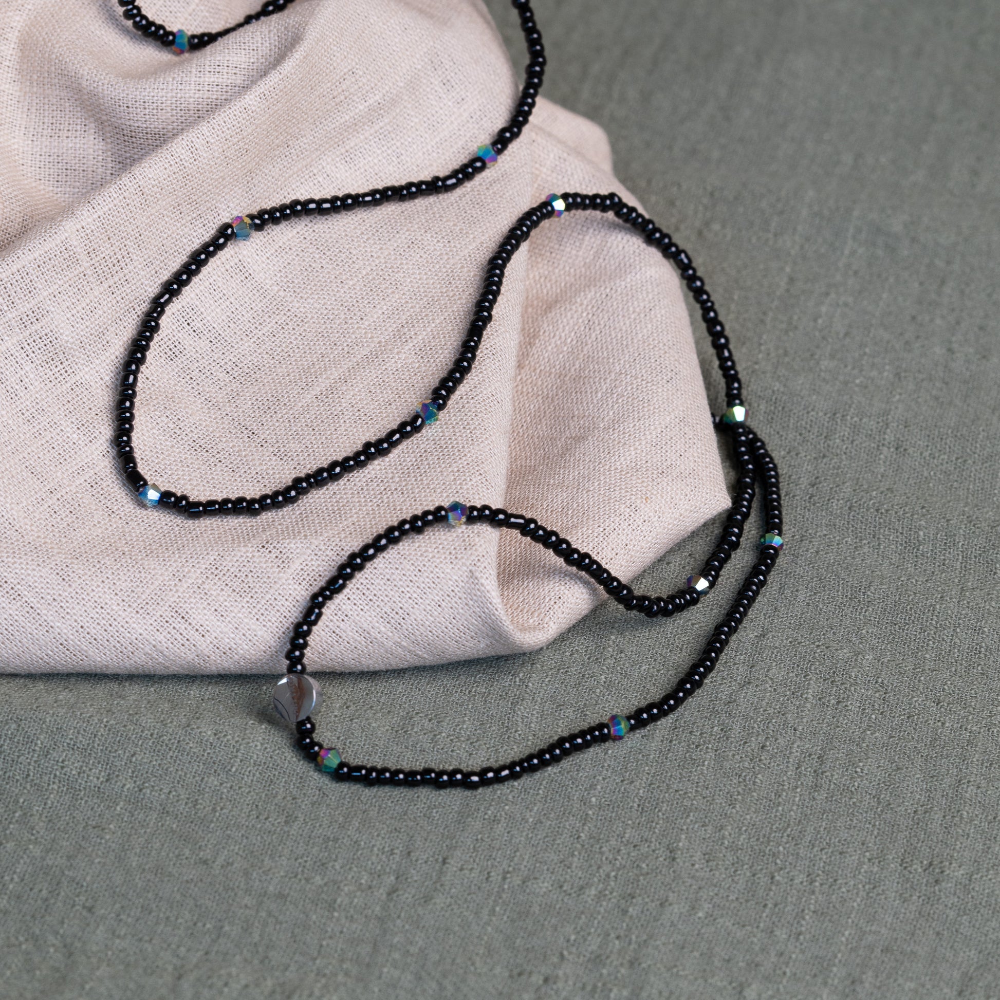 Tòma Lina Black Pearl waist bead, handmade with deep black Ghanaian beads symbolizing protection, grounding and feminine power.