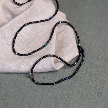 Tòma Lina Black Pearl waist bead, handmade with deep black Ghanaian beads symbolizing protection, grounding and feminine power.
