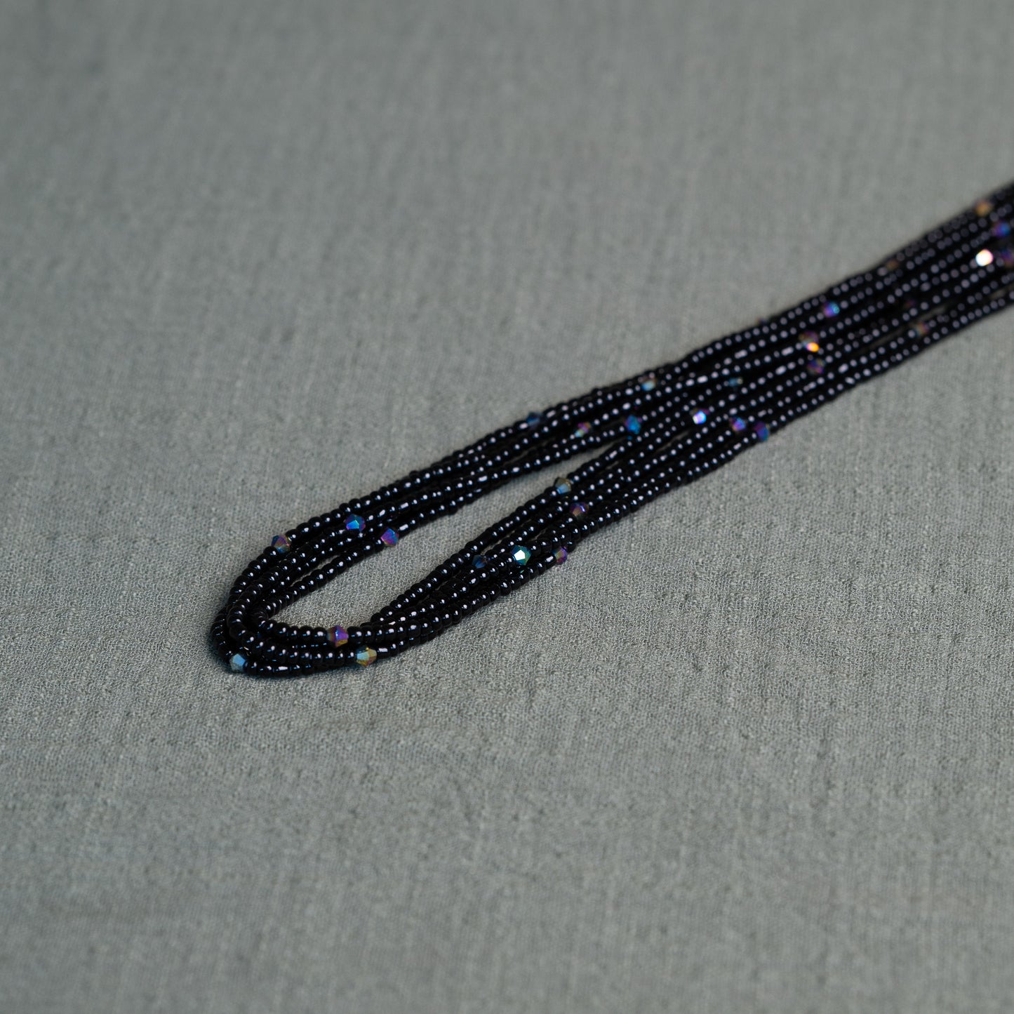 Tòma Lina Black Pearl waist bead, handmade with deep black Ghanaian beads symbolizing protection, grounding and feminine power.