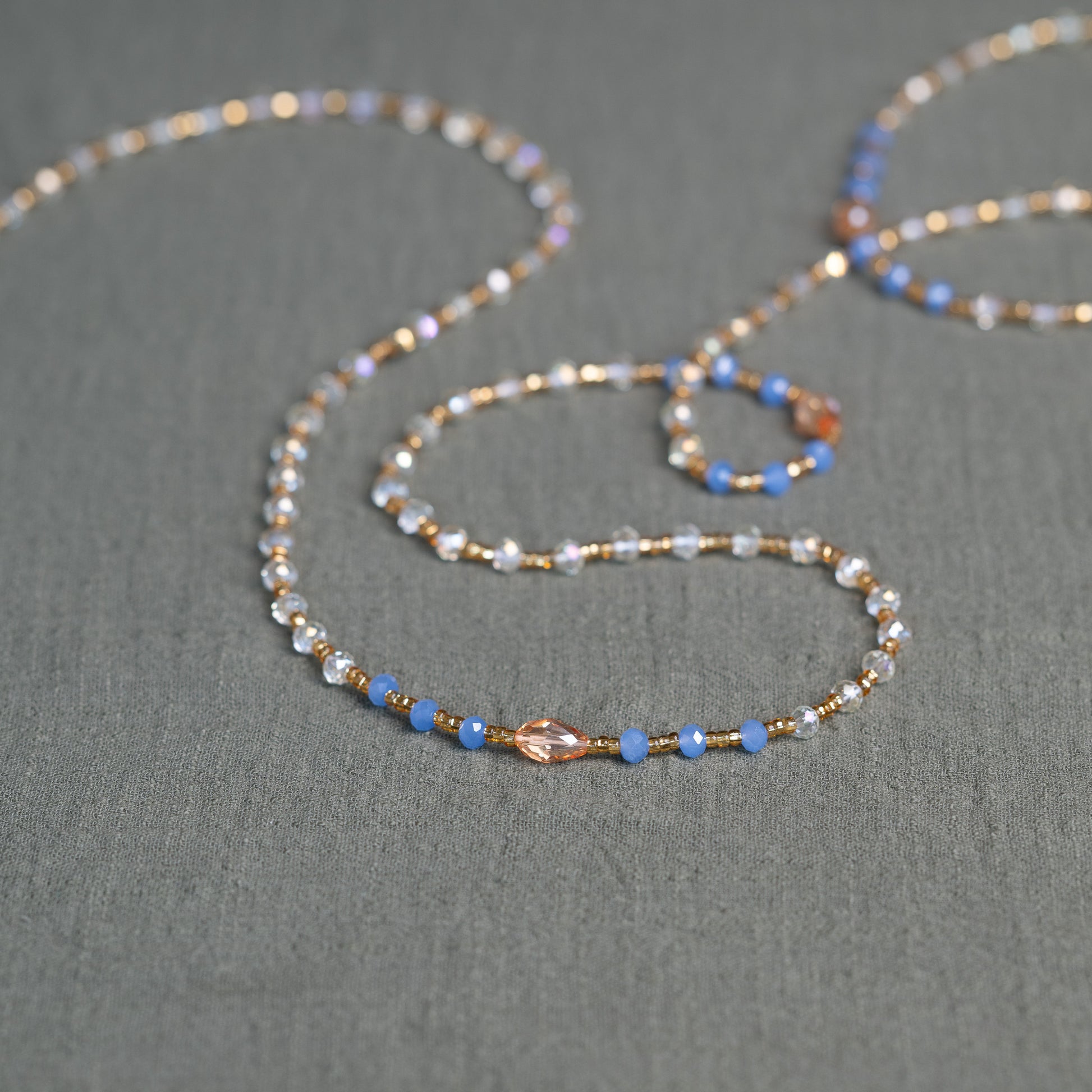 Soft blue and golden handmade waist beads – calming African body jewelry from Ghana designed for emotional healing.