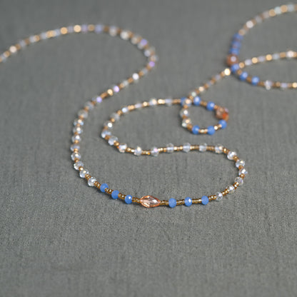 Soft blue and golden handmade waist beads – calming African body jewelry from Ghana designed for emotional healing.