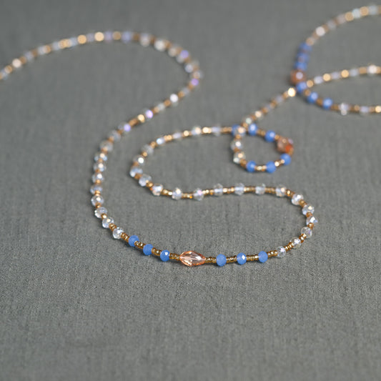 Soft blue and golden handmade waist beads – calming African body jewelry from Ghana designed for emotional healing.