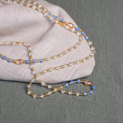 Soft blue and golden handmade waist beads – calming African body jewelry from Ghana designed for emotional healing.