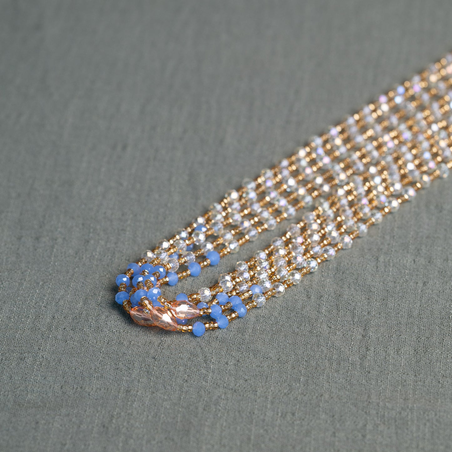 Soft blue and golden handmade waist beads – calming African body jewelry from Ghana designed for emotional healing.