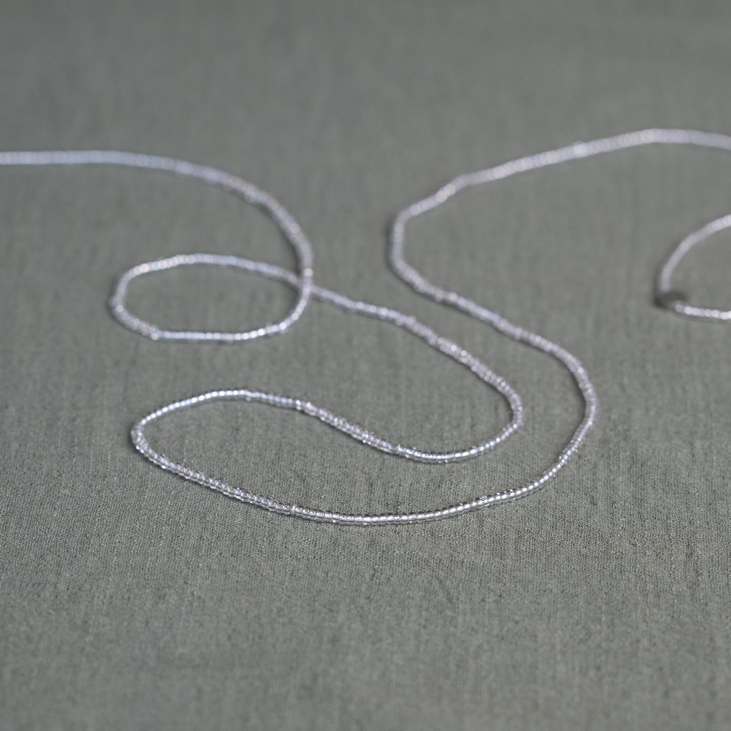 Tòma Lina Clear Beauty waist bead, handmade with transparent Ghanaian beads symbolizing clarity, purity and a fresh new beginning.