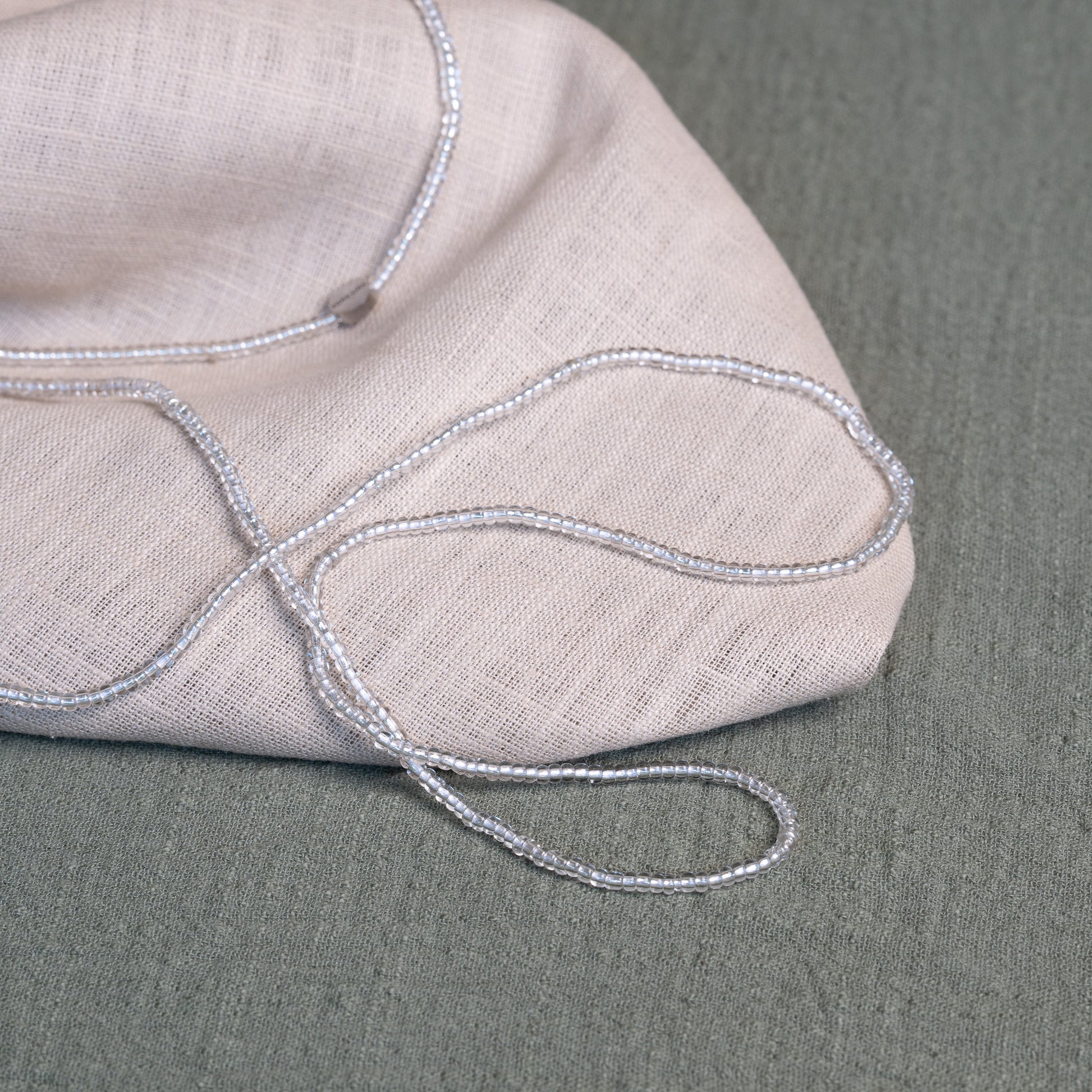 Tòma Lina Clear Beauty waist bead, handmade with transparent Ghanaian beads symbolizing clarity, purity and a fresh new beginning.