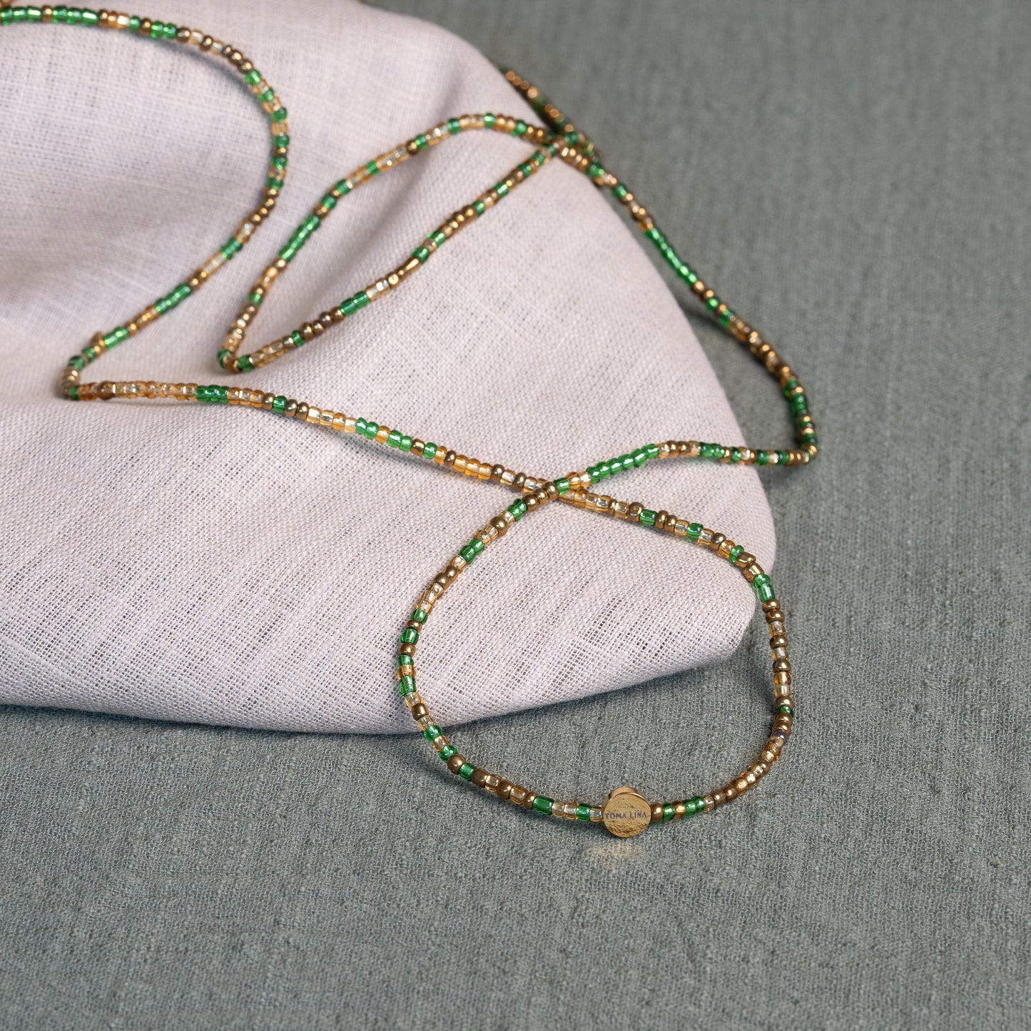 Tòma Lina Emerald Green waist bead, handmade with authentic Ghanaian beads in a deep green shade symbolizing growth and renewal