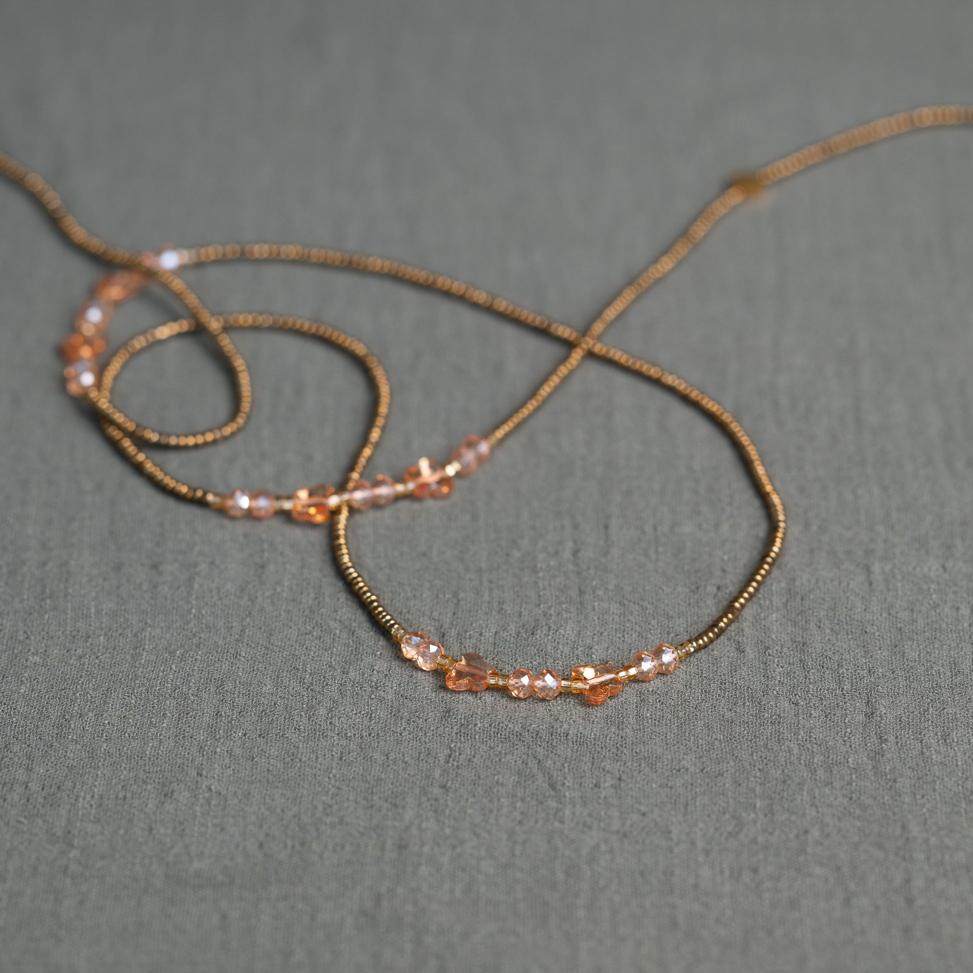 Waist beads with butterfly detail in pink and gold – spiritual African body jewelry handcrafted in Ghana for transformation.