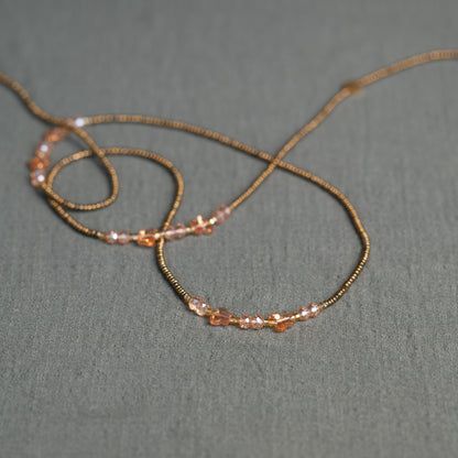 Waist beads with butterfly detail in pink and gold – spiritual African body jewelry handcrafted in Ghana for transformation.