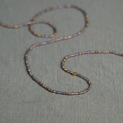 Tòma Lina Purple Rain waist bead, handmade with authentic Ghanaian beads in a rich purple tone symbolizing intuition, empowerment and spiritual depth.