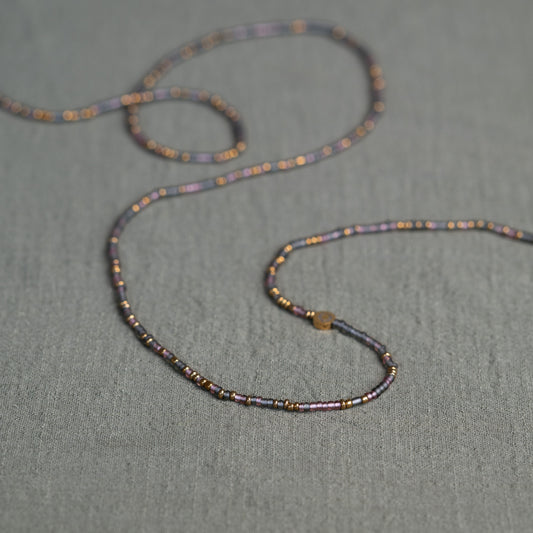 Tòma Lina Purple Rain waist bead, handmade with authentic Ghanaian beads in a rich purple tone symbolizing intuition, empowerment and spiritual depth.