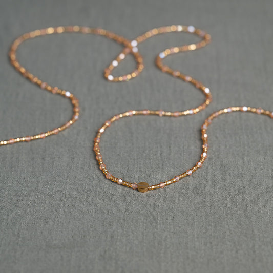 Rose-toned African waist beads with crystal shimmer – tie-on body jewelry symbolizing self-growth and feminine blooming.