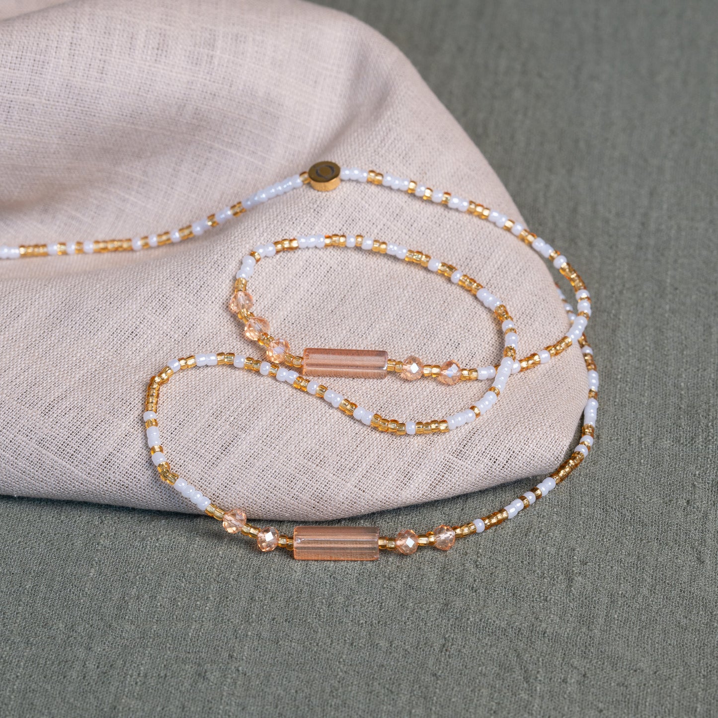 White and gold African waist beads – spiritual tie-on body jewelry handcrafted in Ghana for purity and clarity.