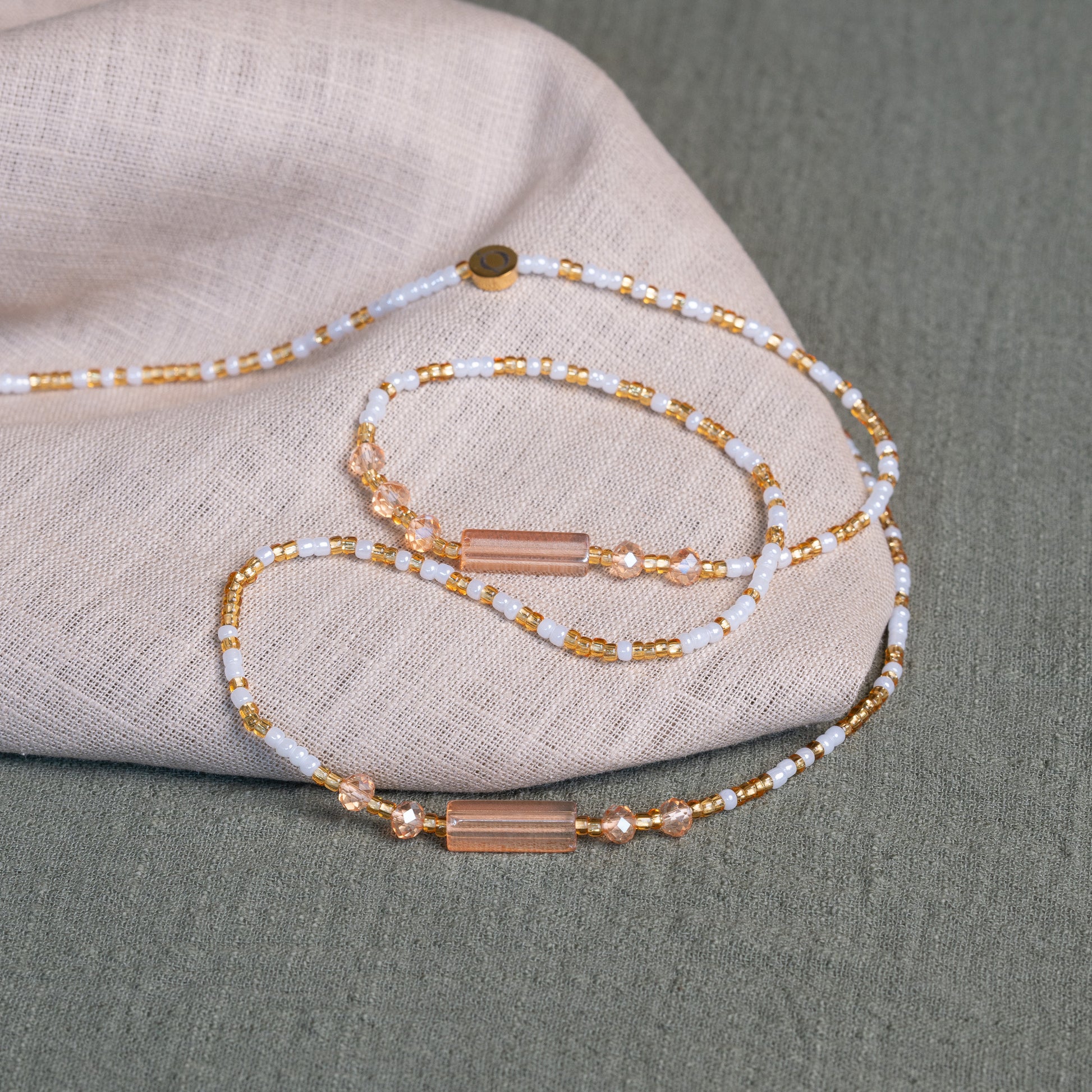White and gold African waist beads – spiritual tie-on body jewelry handcrafted in Ghana for purity and clarity.