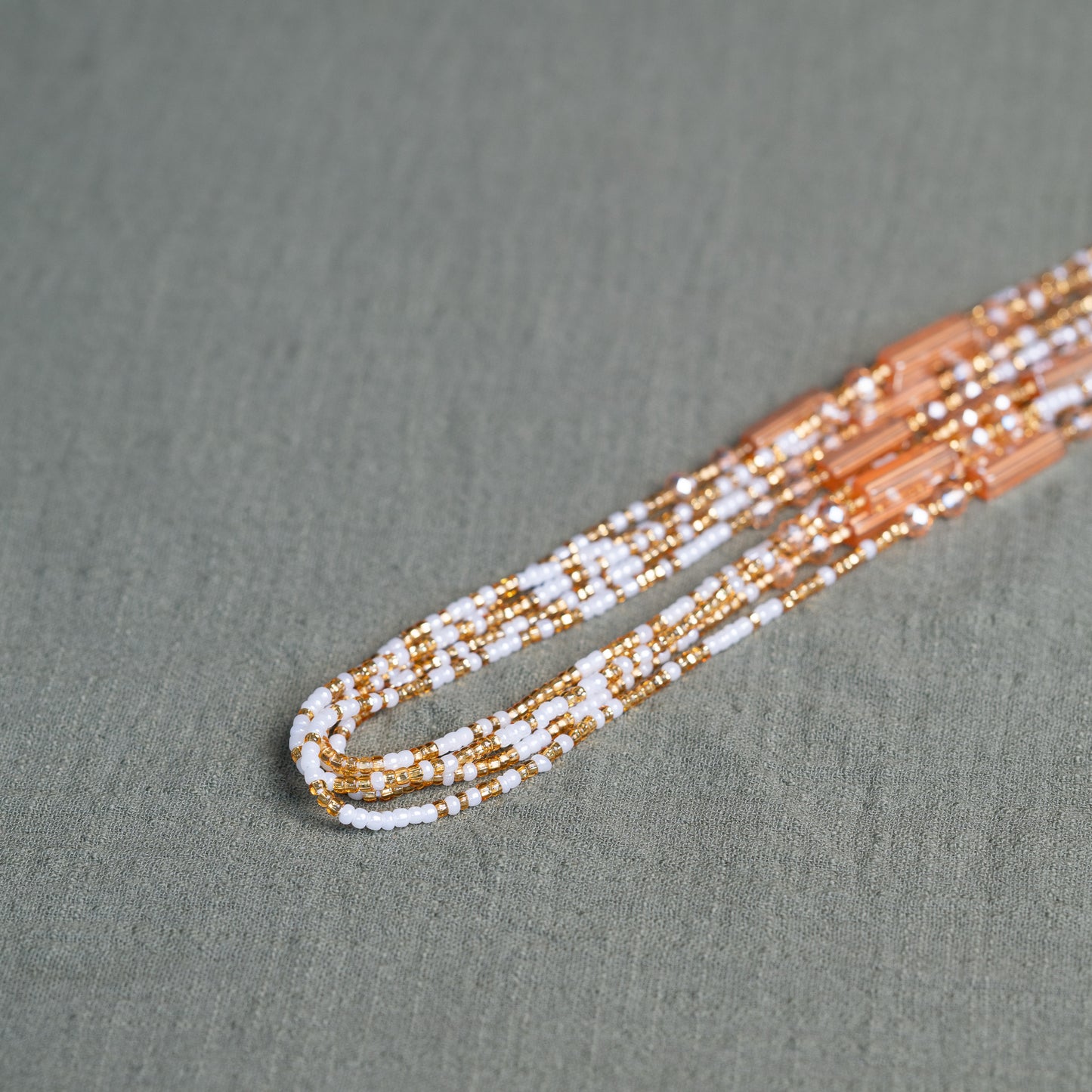 White and gold African waist beads – spiritual tie-on body jewelry handcrafted in Ghana for purity and clarity.