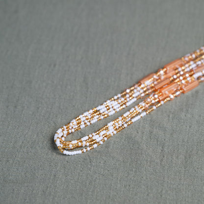 White and gold African waist beads – spiritual tie-on body jewelry handcrafted in Ghana for purity and clarity.